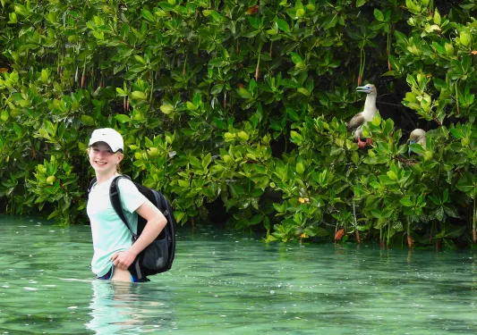 Woman wading in waste=deep water in Ecuador