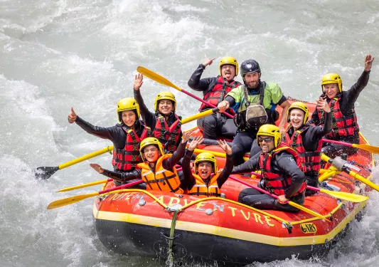 Group of guests white water rafting.