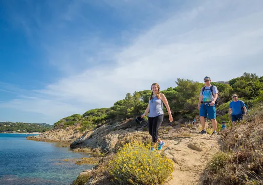 Group of three Backroads guests hiking beside the sea in France