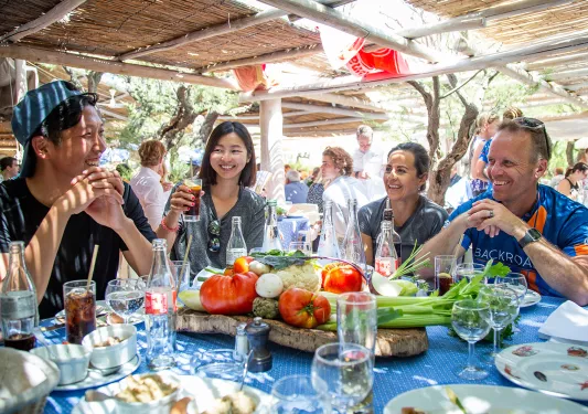 Group of Backroads guests enjoying an outdoor meal in France