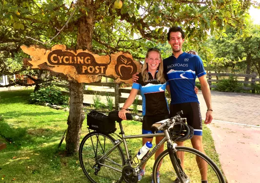 Guests posing in front of "CYCLING POST" sign.