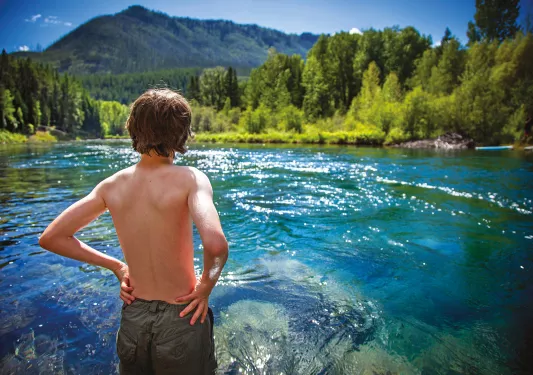 Backroads guest looking out at blue water and mountains