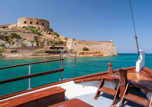 POV shot on boat, looking towards Spinalonga fortress.