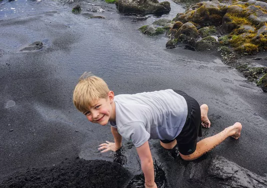 Child playing in a pool of water in Hawaii
