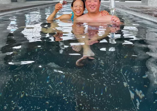 Guests enjoying champagne in hotel pool