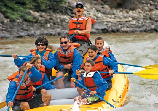 Group of guests white-water rafting.