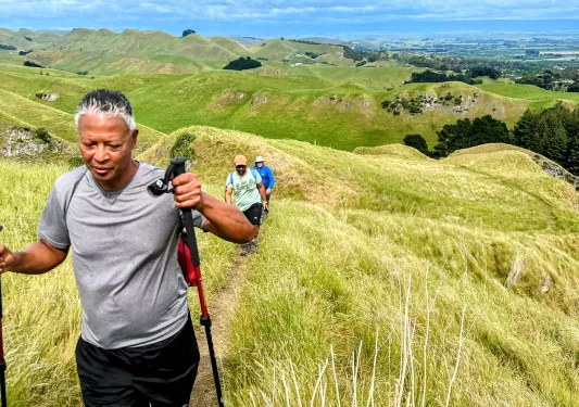 Hiking up a grassy hill in New Zealand