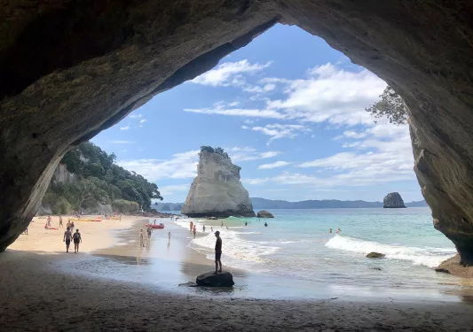 Archway shot looking out towards populated beach.