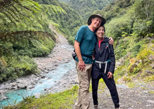 Two people posing next to a stream in New Zealand