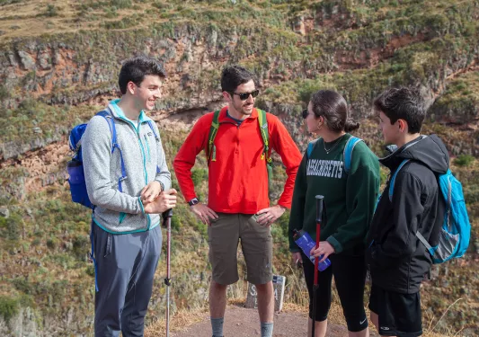 Four guests in hiking gear, talking.