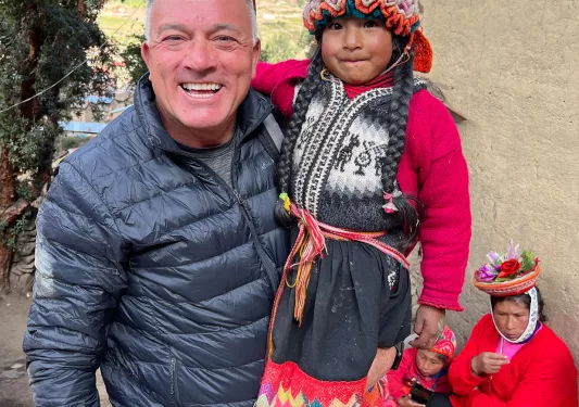 Guest holding young local girl.