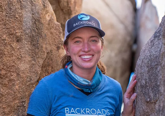 Leader posing between two large boudlers.