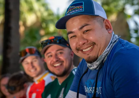 Three guests smiling, looking towards camera.