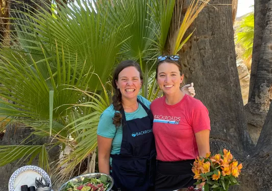 Guest and leader with prepped lunch spread.