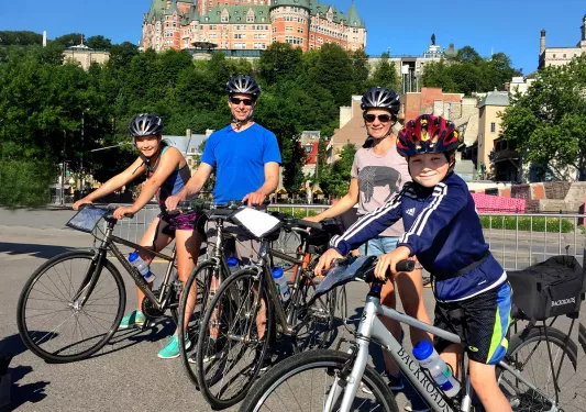 Guest family on their bikes, Fairmont Le Château Frontenac in background.