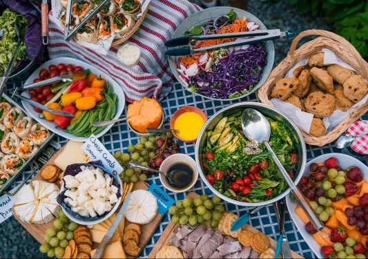 Large lunch spread, salads, veggies, cheeses, cookies, etc.