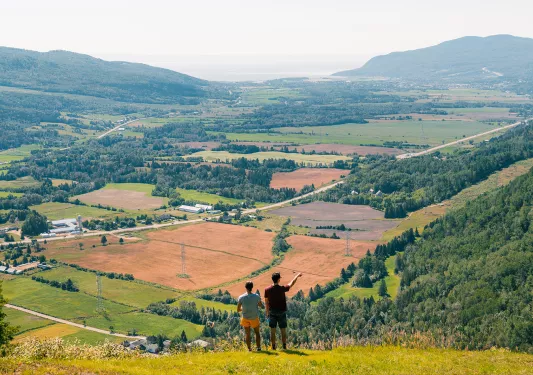 Two hikers overlooking a valley in Quebec, Canada