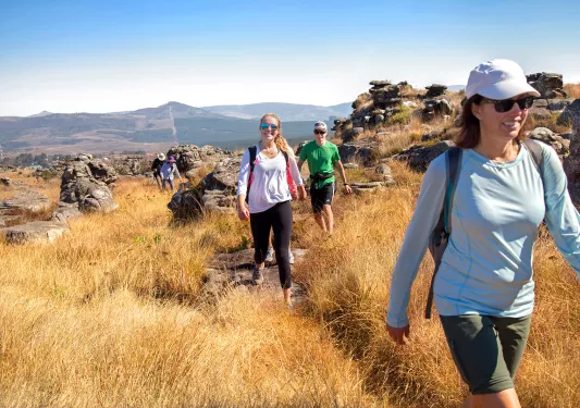 Hikers smiling along trail in Africa