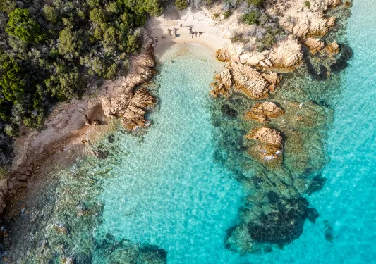 Bird's eye shot of blue-water coastline.