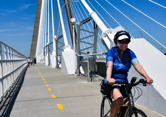 Guest cycling on large bridge.