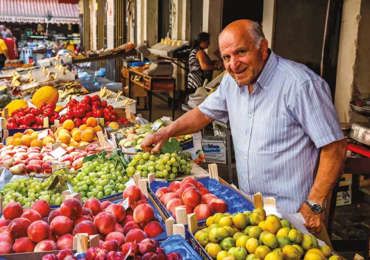 Local fruit vendor, presiding over his booth.