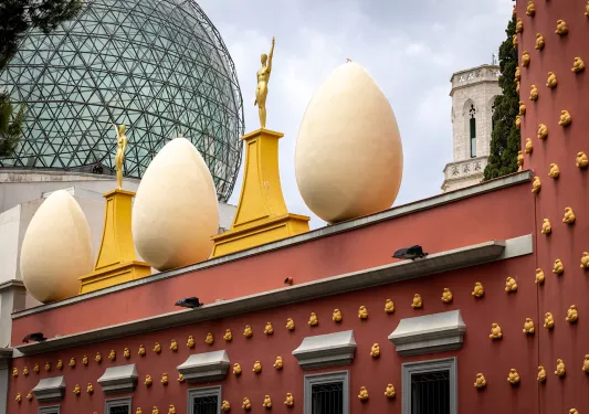Egg shaped sculptures atop a red building