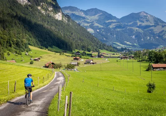 Guest cycling towards mountain village.