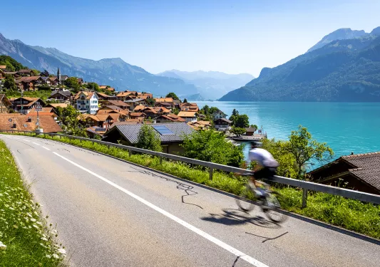 Guest cycling towards red-roofed mountain town.