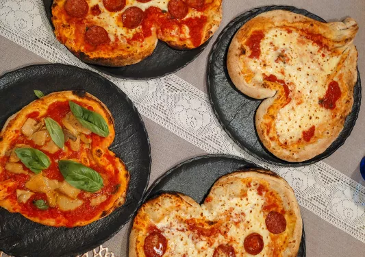 Four heart-shaped pizzas.