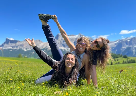 Three guests in a grassy field, posing for camera.