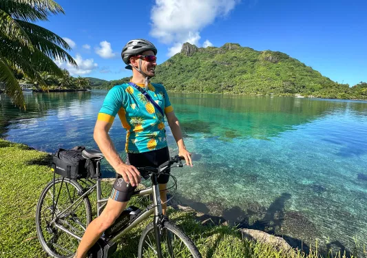Riding a bike next to a bay in Tahiti