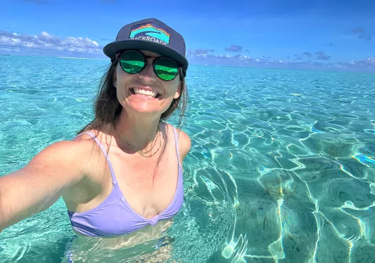 Woman swimming in crystal clear waters in Tahiti