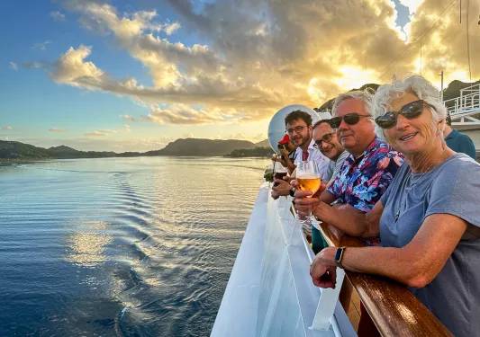 Looking out over the side of a boat in Tahiti at sunset