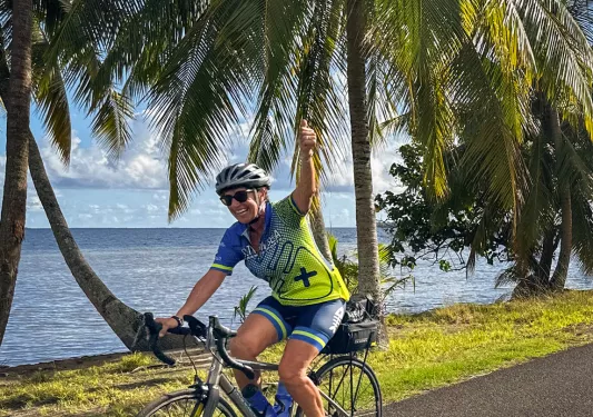 Biking along a palm tree lined shore in Tahiti
