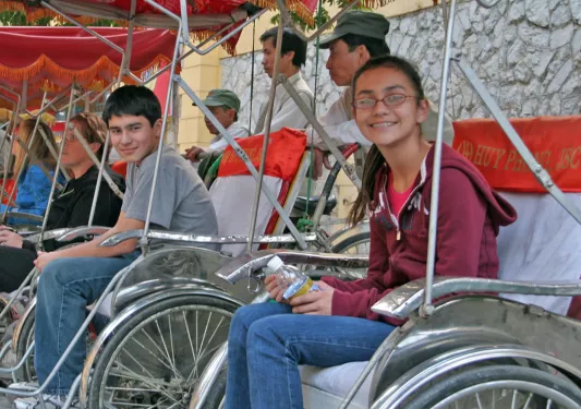 Backroads guests sitting in bike pedal carts in Vietnam