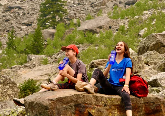 Smiling Backroads guest enjoying a sip of water