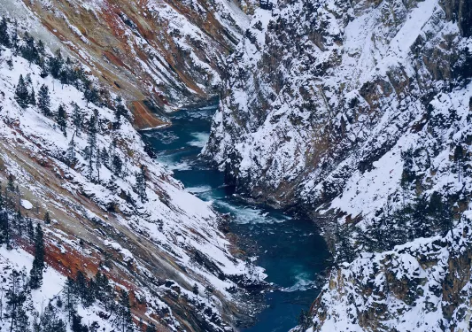 Snow covered mountains and rushing river