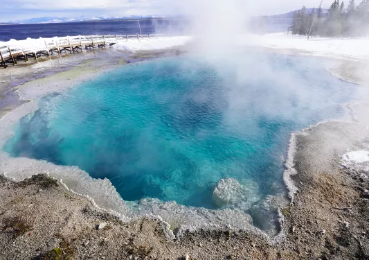 Hot spring surrounded by snowy ground