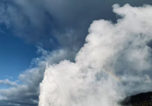 Geyser erupting on a snowy landscape