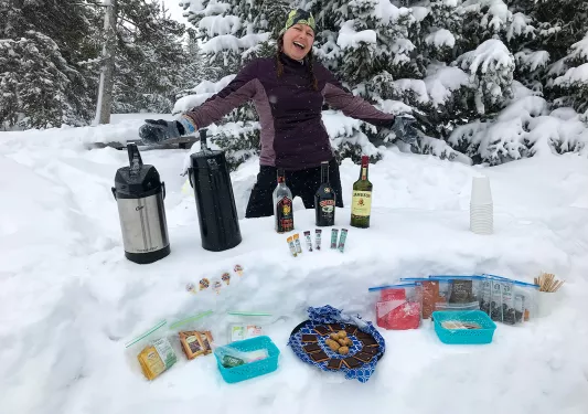 Backroads leader smiling with hot drinks and snacks
