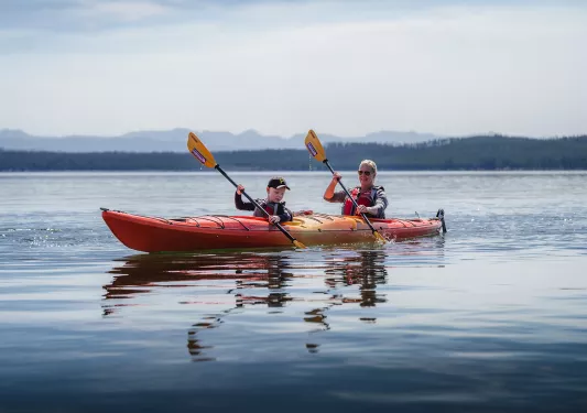Backroads guests canoeing through blue water