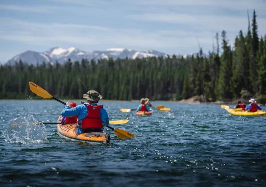 Backroads guests canoeing in blue lake