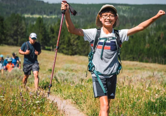 Young Backroads guests smiling while hiking
