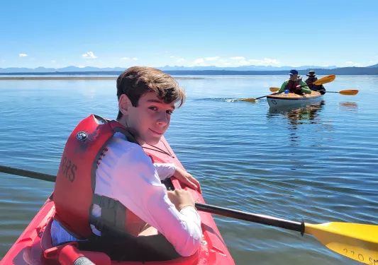 Backroads guest smiling while kayaking
