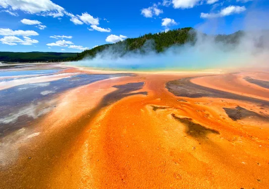 Orange sand leading up to smoking hot springs 