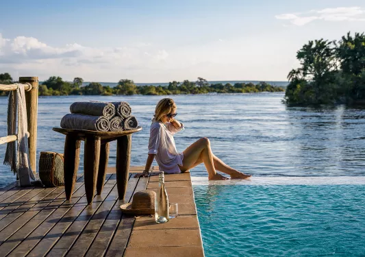 Woman with her feet in the water at Sanctuary Sussi & Chuma