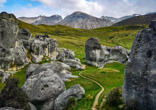 Winding path among large rocks and boulders in New Zealand