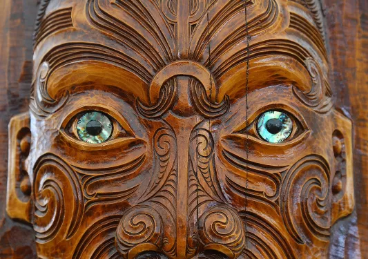 Carved face in Maori style, New Zealand