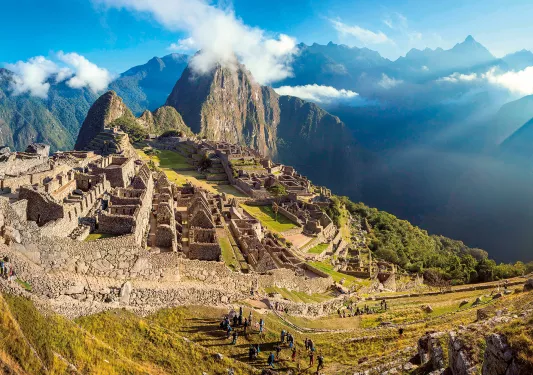 Bird's eye shot of Machu Picchu, large group of people in foreground.