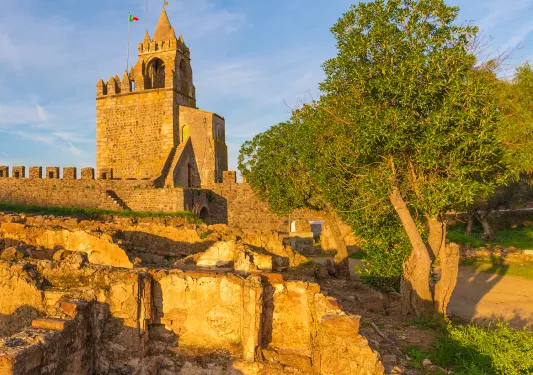 Wide shot of Montemor-o-Novo Castle during sunset.